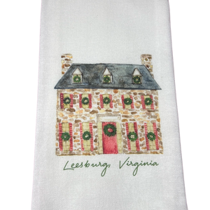 hand towel with historical stone front home with Christmas wreaths hanging in the windows. Bottom of hand towel personalized with Leesburg, Va